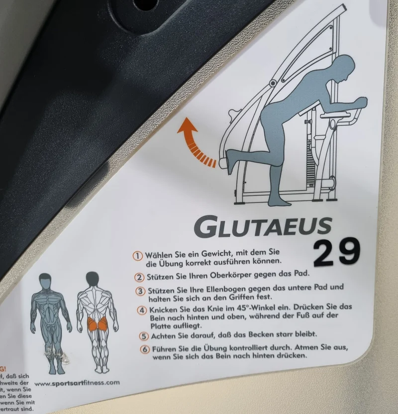 SportsArt Gluteus Maschine S955 A955 N955 Pomaschine stehend, Glutes Kick Radial, Rahmenfarbe Silber, Polsterfarbe Orange/Grau, gebraucht - überholter Zustand